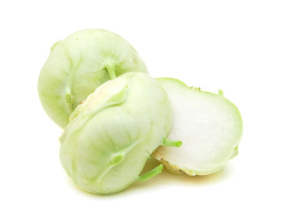 Three slices of kohlrabi, on a white background.