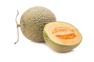 Whole and halved cantaloupe on a white background